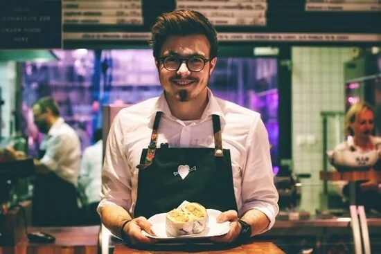 Part-time waiter in a restaurant.