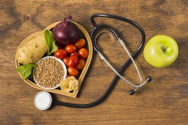 Basket with vegetables and a stethoscope on the table.