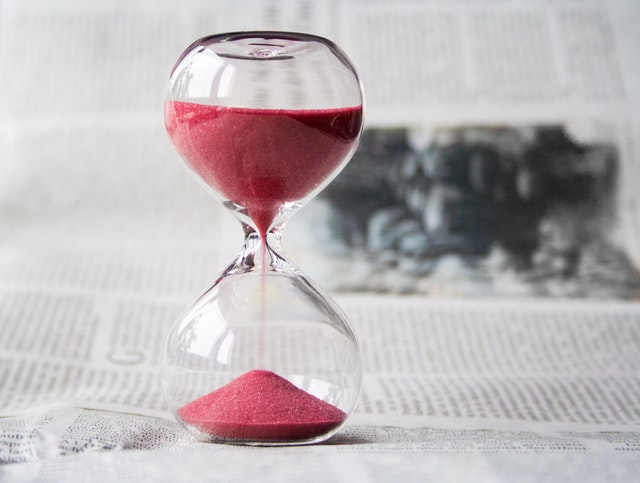 Hourglass with red sand.