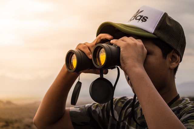 SPM student using binoculars.