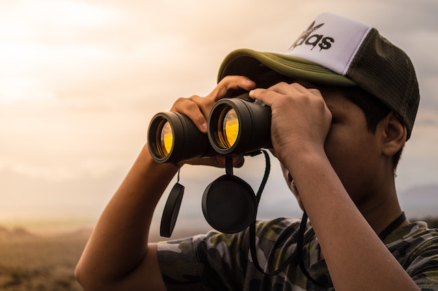Student using binoculars.